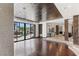 Bright living room with hardwood floors, fireplace and sliding glass doors that open to the pool at 9501 Balatta Canyon Ct, Las Vegas, NV 89144