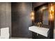 Stylish powder room features a floating sink, textured wallpaper, and modern lighting fixtures at 9501 Balatta Canyon Ct, Las Vegas, NV 89144