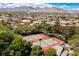 Aerial view of tennis courts in a community with mountain views and mature landscaping at 9501 Balatta Canyon Ct, Las Vegas, NV 89144