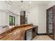The lovely wine bar features stone columns and a sleek wine refrigerator at 9501 Balatta Canyon Ct, Las Vegas, NV 89144