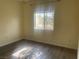 A bright bedroom with a window providing natural light and wood-look floors at 1050 E Cactus Ave # 2110, Las Vegas, NV 89183