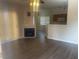 Living room with wood flooring, fireplace, and access to the kitchen and dining area at 1050 E Cactus Ave # 2110, Las Vegas, NV 89183