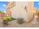 A private backyard provides serene rock landscaping, an AC unit, and a green space at 10525 Shiny Skies Dr, Las Vegas, NV 89129