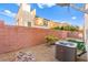 Backyard features low-maintenance landscaping, privacy fencing, and is equipped with an efficient AC unit at 10525 Shiny Skies Dr, Las Vegas, NV 89129