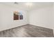 Minimalist bedroom featuring light gray floors, a window, and white walls at 10525 Shiny Skies Dr, Las Vegas, NV 89129
