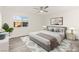 Cozy bedroom with a ceiling fan, a neutral color scheme, and a large window at 10525 Shiny Skies Dr, Las Vegas, NV 89129