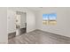 Bright bedroom features hardwood floors and a large window with scenic city views at 10525 Shiny Skies Dr, Las Vegas, NV 89129