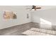 This bedroom features wood-look floors and two windows at 10525 Shiny Skies Dr, Las Vegas, NV 89129