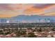 The skyline view captures the allure of city lights against a colorful sunset backdrop at 10525 Shiny Skies Dr, Las Vegas, NV 89129