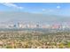 Expansive city view showcases the skyline and verdant trees creating a unique urban oasis at 10525 Shiny Skies Dr, Las Vegas, NV 89129