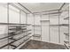 Walk in closet with custom shelving and drawers for maximum storage and organization at 10525 Shiny Skies Dr, Las Vegas, NV 89129