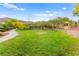 Lush community park showcasing an expanse of manicured grass and mature trees, providing a serene and inviting outdoor space at 10525 Shiny Skies Dr, Las Vegas, NV 89129