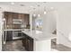 This gorgeous kitchen features a central island, stainless appliances, and sleek countertops at 10525 Shiny Skies Dr, Las Vegas, NV 89129