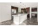 This open kitchen features a central island, stainless appliances, and sleek countertops at 10525 Shiny Skies Dr, Las Vegas, NV 89129