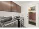 Laundry room featuring side by side washer and dryer and upper cabinets for extra storage at 10525 Shiny Skies Dr, Las Vegas, NV 89129