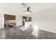 Spacious living room with tiled floors, ceiling fan, and an open layout that connects seamlessly to the kitchen at 10525 Shiny Skies Dr, Las Vegas, NV 89129
