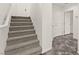 Carpeted staircase with white trim leading to an upper level of the home at 10525 Shiny Skies Dr, Las Vegas, NV 89129