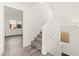 This staircase has carpeted steps and a white railing at 10525 Shiny Skies Dr, Las Vegas, NV 89129