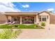 Charming backyard featuring a covered patio, artificial turf, desert landscaping, and outdoor seating at 10713 Shoalhaven Dr, Las Vegas, NV 89134