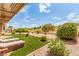 Backyard view with artificial turf, lounge chairs, well-manicured landscaping, and desert scenery at 10713 Shoalhaven Dr, Las Vegas, NV 89134