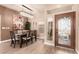 Elegant dining room with a chandelier, modern art, and seating for six at 10713 Shoalhaven Dr, Las Vegas, NV 89134