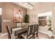 Cozy dining room with a modern chandelier, seating for six, and natural light at 10713 Shoalhaven Dr, Las Vegas, NV 89134