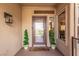 Inviting front entryway features a decorative glass door and manicured topiaries at 10713 Shoalhaven Dr, Las Vegas, NV 89134