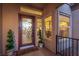 Inviting front door with decorative glass, sidelight window, and manicured greenery at 10713 Shoalhaven Dr, Las Vegas, NV 89134