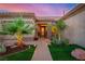 Inviting front entrance with manicured landscaping and a well-lit walkway at 10713 Shoalhaven Dr, Las Vegas, NV 89134