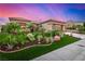 Inviting home with desert landscaping, manicured lawn, and a spacious two-car garage at 10713 Shoalhaven Dr, Las Vegas, NV 89134