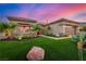 Well-manicured front yard with desert landscaping, green grass, and charming exterior lighting at 10713 Shoalhaven Dr, Las Vegas, NV 89134