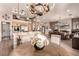 Bright, open-concept kitchen and living room featuring modern appliances and decorative lighting at 10713 Shoalhaven Dr, Las Vegas, NV 89134