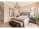 Elegant main bedroom featuring a plush bed, decorative artwork, and wood flooring at 10713 Shoalhaven Dr, Las Vegas, NV 89134
