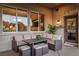 Stylish outdoor patio with comfortable seating and a view through large windows at 10713 Shoalhaven Dr, Las Vegas, NV 89134