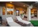 Inviting covered patio with lounge chairs, outdoor seating, and view of the interior through large windows at 10713 Shoalhaven Dr, Las Vegas, NV 89134