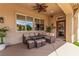 Inviting covered patio with a dining set, ceiling fan, and natural light, perfect for outdoor relaxation at 10713 Shoalhaven Dr, Las Vegas, NV 89134