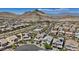 An elevated view of a vibrant community nestled among rolling hills and meticulously planned streets at 10954 Free Flow Pl, Las Vegas, NV 89138