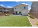Spacious backyard featuring lush artificial turf and privacy fencing for outdoor enjoyment at 10954 Free Flow Pl, Las Vegas, NV 89138