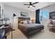 Bedroom featuring a bed, bedside tables, a large window, and gray accents at 10954 Free Flow Pl, Las Vegas, NV 89138