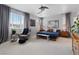 Spacious primary bedroom featuring a sitting area, large bed, and modern ceiling fan at 10954 Free Flow Pl, Las Vegas, NV 89138