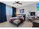Bedroom features a bed, bedside tables, a large window, and blue curtains at 10954 Free Flow Pl, Las Vegas, NV 89138