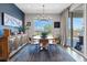Inviting dining area features a large window with views, elegant chandelier, and sliding glass doors at 10954 Free Flow Pl, Las Vegas, NV 89138