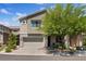 Contemporary two-story home featuring a neutral color scheme, paver driveway and low maintenance landscaping at 10954 Free Flow Pl, Las Vegas, NV 89138