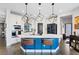 Modern kitchen featuring a large island with seating, stainless steel appliances, and white cabinetry at 10954 Free Flow Pl, Las Vegas, NV 89138
