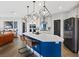 Modern kitchen with island seating, stylish pendant lights, and stainless steel appliances at 10954 Free Flow Pl, Las Vegas, NV 89138