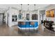 Modern kitchen featuring a large island with seating, stainless steel appliances, and white cabinetry at 10954 Free Flow Pl, Las Vegas, NV 89138