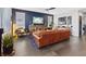 Stylish living room boasts a leather sofa, wood accents, and sleek tile flooring throughout at 10954 Free Flow Pl, Las Vegas, NV 89138