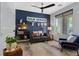 Office features a ceiling fan, a dark couch, a blue armchair, and a window at 10954 Free Flow Pl, Las Vegas, NV 89138