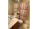 Cozy bathroom featuring a tub, neutral patterned shower curtain, and ample counter space by a mirror at 11021 Pentland Downs St, Las Vegas, NV 89141