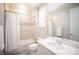 This bathroom features a tiled shower with a shower curtain and a white vanity at 12018 Vento Forte Ave, Las Vegas, NV 89138